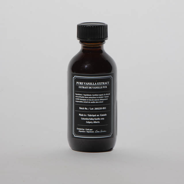Bottle of pure vanilla extract on a gray background